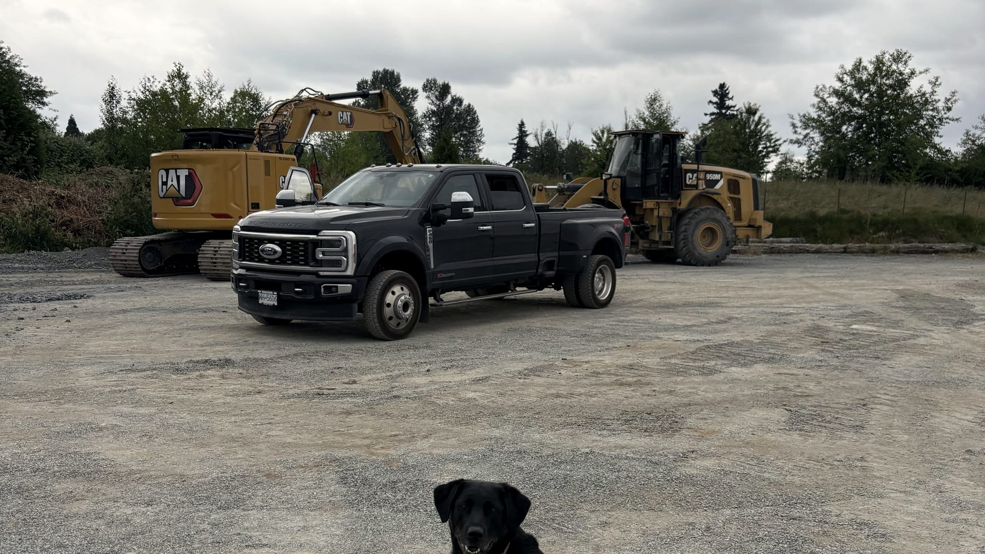 The JMEX crew truck with a Cat excavator and wheel loader on the yard