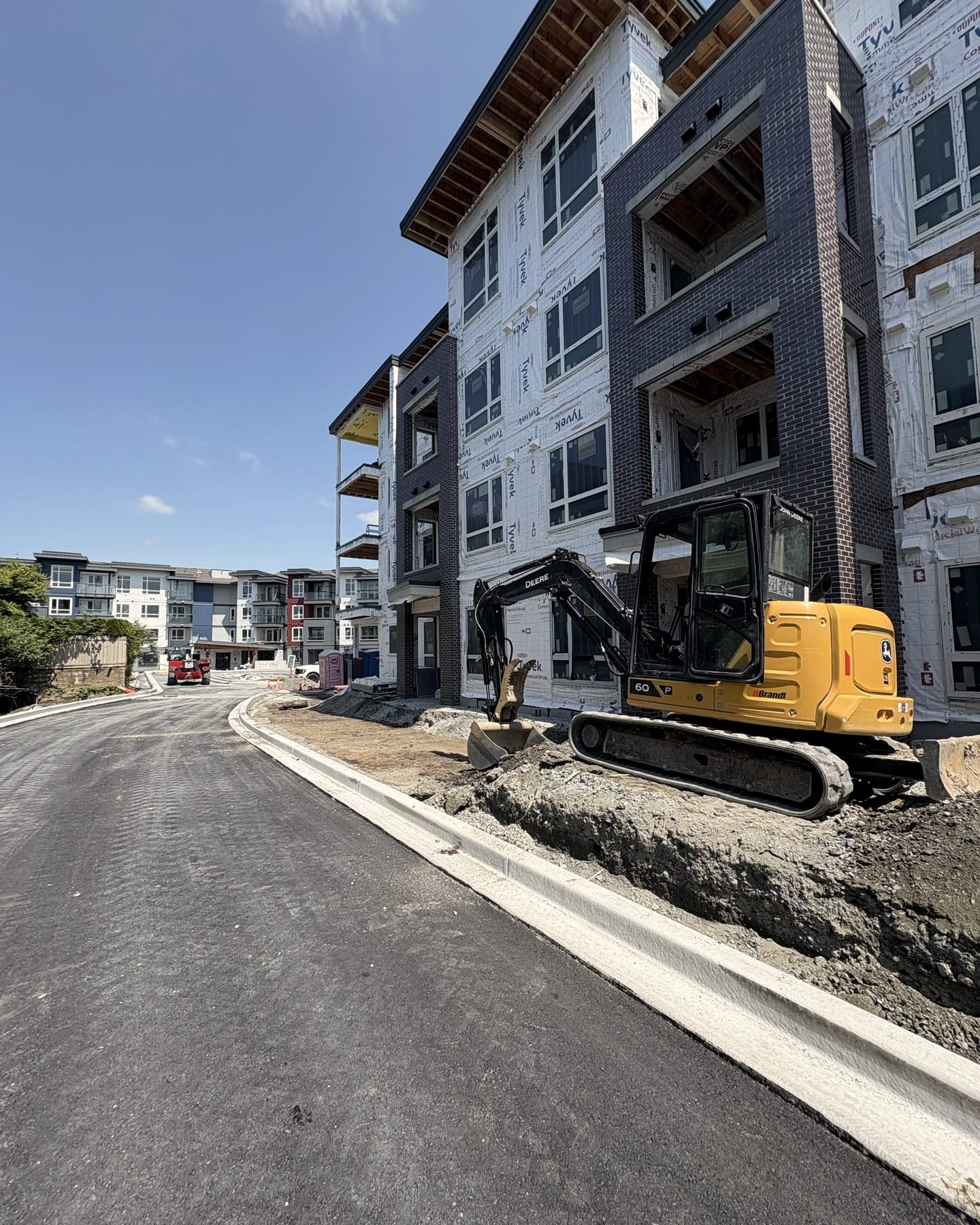 An excavator doing site work on a Fraser Valley project
